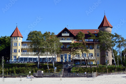 A view of historic hotel building on sand dune, Leba beach, Baltic Sea, Poland. Castle on the beach. Beautiful sunny weather