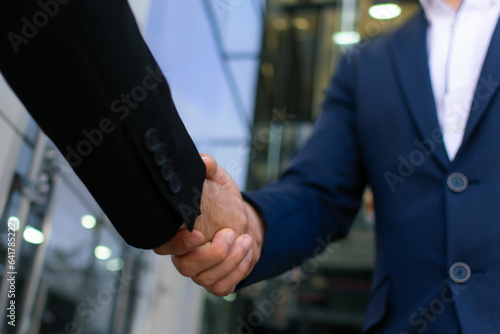 Business handshake for teamwork of business merger and acquisition,successful negotiate,hand shake,two businessman shake hand with partner to celebration partnership and business deal concept