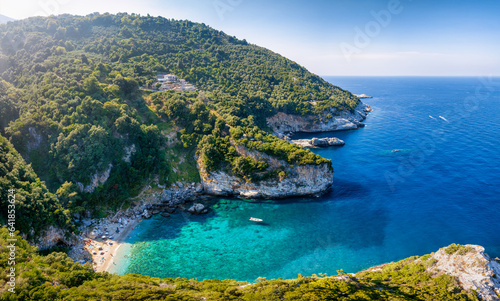 The remote beach of Fakistra, North Pelion mountain, Greece, with emerald shining sea and thick pine forest