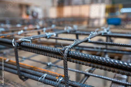 Steel rods or bars used to reinforce concrete, in warehouse at the metalworking shop. Modern industrial enterprise.