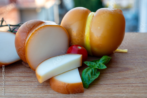 Italian semi hard handmade smoked scamorza cheese, from cow milk from Apulia or Calabria regions close up