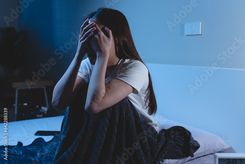 Insomnia at night concept, Selective focus at the time in alarm clock and the person covering her face because can not sleep as background