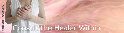 Consult the Healer Within Message Banner - female in white with hands laid over heart area against a flowing pale pink peach background with space for text 