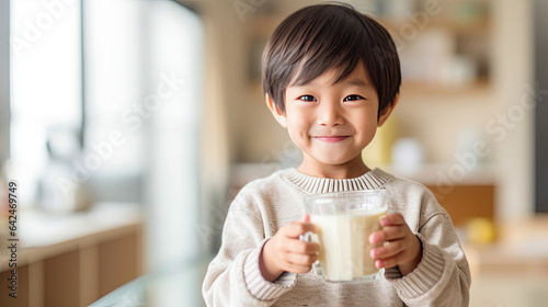 Asian little boy cute kid holding a cup of milk, feel happy enjoy drinking milk in kitchen. Generative Ai