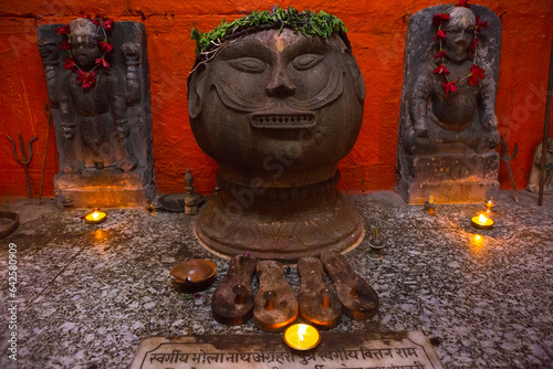 Varanasi, Uttar Pradesh, India. A stone head of Brahma from the Temple of Bhairav. Pishach Mochan - the place where, according to the sacred legend, the god Bhairava tore off the head of Brahma.