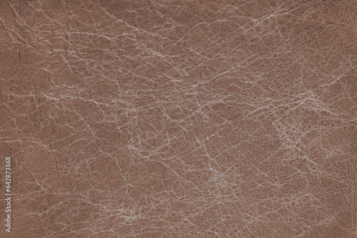 Genuine brown coarse textured leather, eco friendly leatherette background. Material for upholstery and interior design, sport items and clothes. Wallpaper, banner, backdrop.