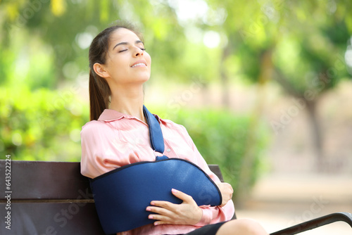 Happy disabled woman breathing in a park