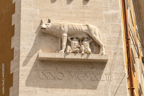 Relief of a she-wolf suckling ancient Capitoline children on the wall of the house in Rome, Italy