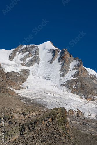 Gran Paradiso mountain and glacier view from chabod hut, white peak against blue sky. landscape. global warming melting the ice