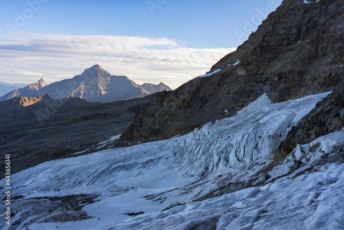 View of Grivola mountain among Valsavarenche and Cogne valley from Gran Paradiso glacier at sunrise