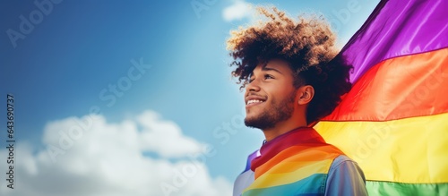 Digital image of a confident biracial man celebrating national coming out day by waving a rainbow flag copy space for lgbt awareness and support of the queer community