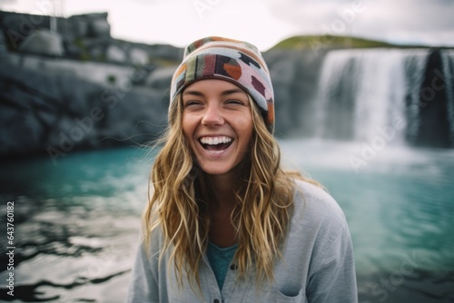 Lifestyle portrait photography of a joyful girl in her 40s wearing a cool snapback hat at the blue lagoon in reykjavik iceland. With generative AI technology