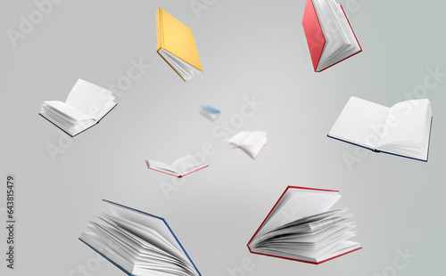 Many flying books on grey background