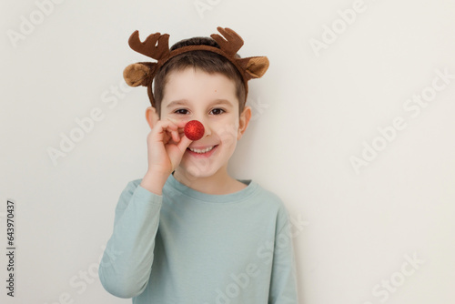 Boy with reindeer horns red nose