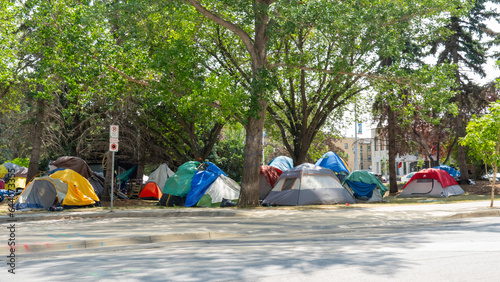Homeless tent encampment under the trees in downtown. Regina, Saskatchewan, Canada - July 17, 2023. 
