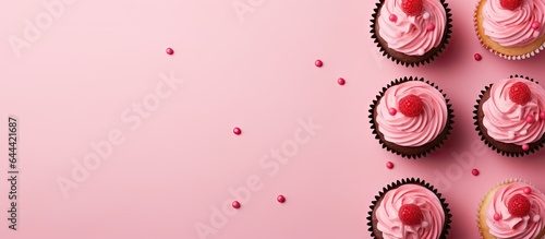 Raspberry filled cupcakes with a polka dot design isolated pastel background Copy space