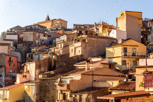 scenic view of historical center of a city with old vintage yellow buildings and houses with orange tiled roof and beautiful blue sky on background