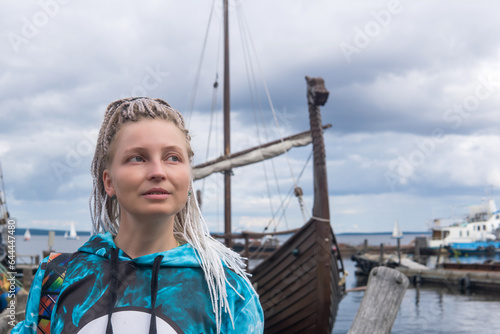 woman tourist went ashore after sailing in a modern replica of anсient viking longship