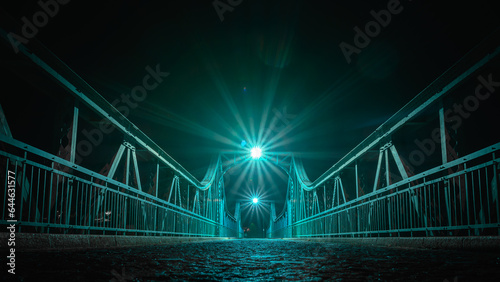 Wroclaw, the Bartoszowicki bridge, a metal structure illuminated at night, enabling crossing to the other bank of the Odra River.