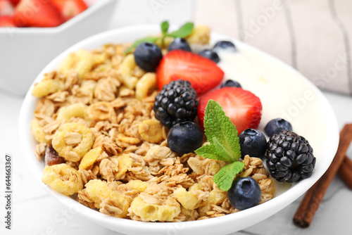 Tasty oatmeal, yogurt and fresh berries in bowl, closeup. Healthy breakfast