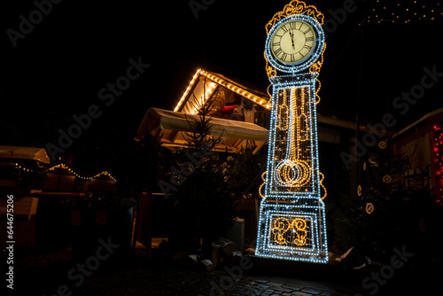 Holiday Decorated and illuminated Clock street at night in Gdansk Poland. Beautiful Christmas fair in the old town at night. Advent winter time in Europe background. Christmas Markets in December