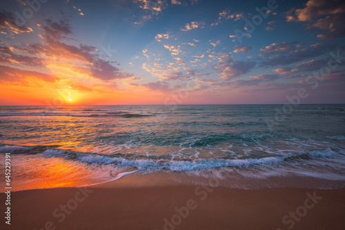 Beautiful cloudscape over tropical sea and beach shore, sunrise over ocean horizon