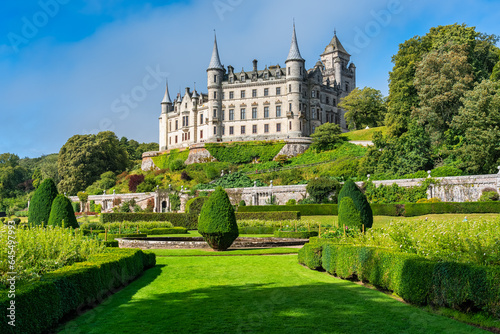 Medieval Dunrobin Castle on a hill and magnificent gardens at the foot of the castle, Scotland, UK.