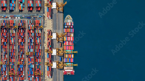 Industrial import-export port prepare to load containers. Aerial top view container ship in export and import global business and logistic. Global transportation and logistic business.