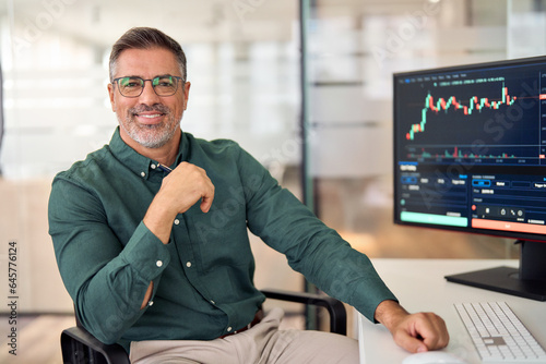 Smiling mature business man crypto broker, financial investor, trader or expert adviser at work, portrait. Digital trade finance exchange market, asset management, stock funds investment analysis.