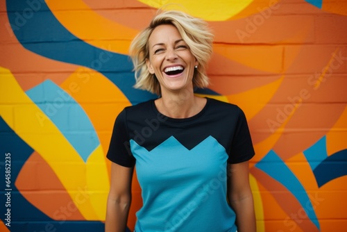 Portrait photography of a Swedish woman in her 40s wearing a fun graphic tee against an abstract background