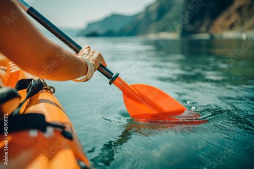 Kayak paddle sea vacation. Person paddles with orange paddle oar on kayak in sea. Leisure active lifestyle recreation activity rest tourism travel