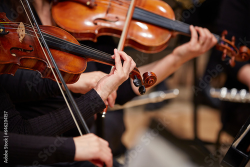 Close up of musician hands playing violin