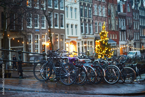 Bicycles parked on a street on a rainy winter day in Amsterdam, the Netherlands