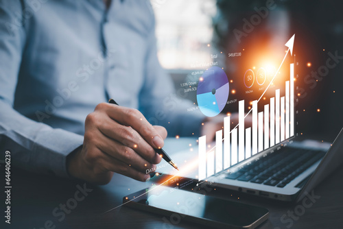 Businessman interacting with laptops, phones, and tablets with featuring stock tickers or graphs, cryptocurrency and new trading platforms, ideas and perspectives, Stock investment,New technology