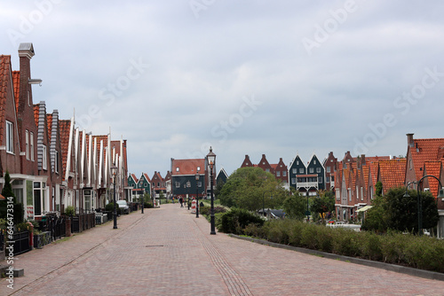 Classic Dutch houses on a street. Cute buildings with red tiles roof. Architecture of the Netherlands. 