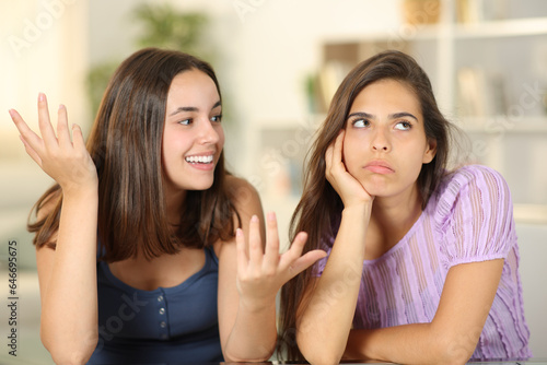 Woman ignoring the conversation of her friend