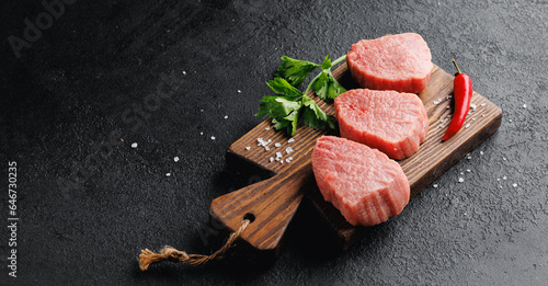 Raw Steak Fresh meat veal fillet on wooden board, dark background top view