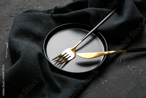 Stylish table setting with napkin on dark background