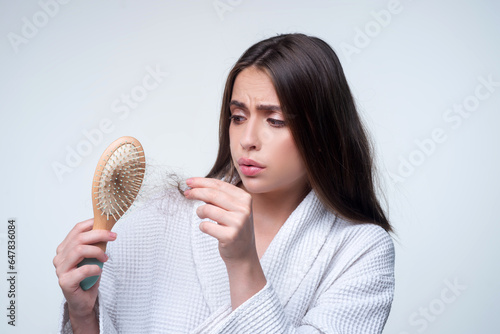 Closeup hair loss, hair fall in hairbrush, stress problem of woman with a comb.