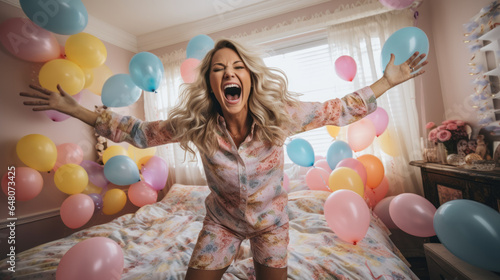 Happy woman dancing at home on her birthday in her pajamas, surrounded by a sea of colorful balloons, room is filled with laughter and the joy of party celebration