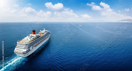 Aerial view of a generic cruise ship traveling with speed over blue ocean with copy space