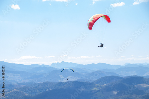 paragliders in the sky over the mountains