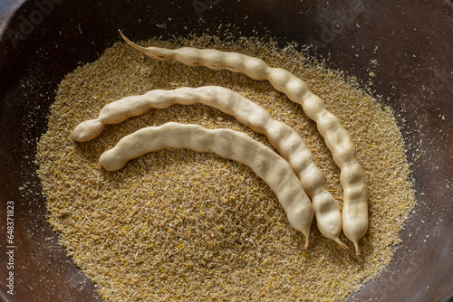 Three mesquite pods and flour