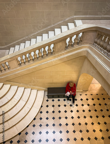 woman waiting on the stairs of grand bourgeois palace house