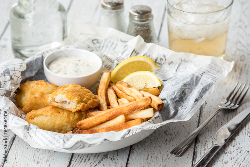 A close up of a serving of fresh fish and chips ready for eating.