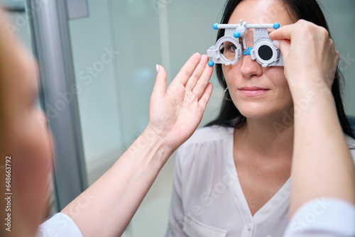 Ophthalmic professional performing monocular subjective refraction on patient