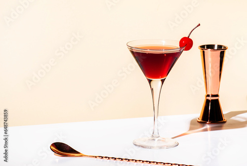 Black Manhattan alcoholic cocktail with whiskey and red vermouth garnished with maraschino cherry in martini glass. Beige background, hard light