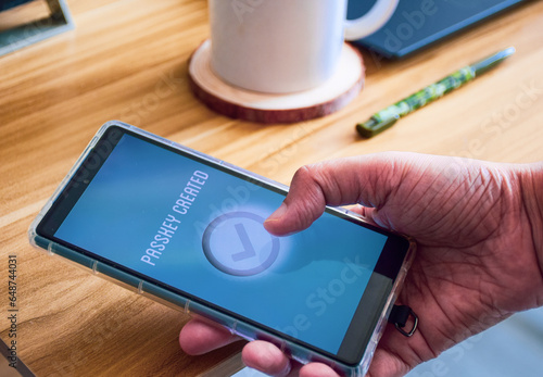 Woman finishing the steps to create passkey in her phone. Passwordless login verification authentication system in digital device for more security.