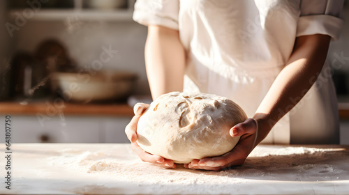 Close up of a woman's hands preparing dough to make bread in a home kitchen 