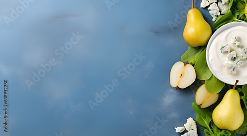 Pear and blue cheese banner with copy space. Whole and halfed pears and pices of blue cheese on light blue concrete background. Healthy eating concept. Vegetarian snacks